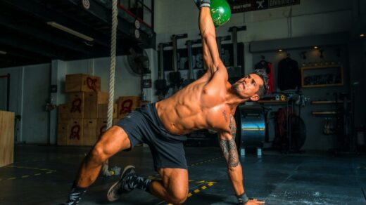 man in black shorts and black tank top doing push up